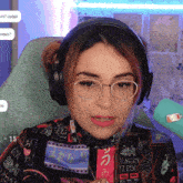 a woman wearing glasses and headphones has a sticker that says all the feels