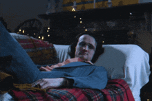 a man is laying on a couch with his feet up
