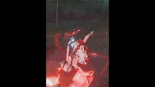 a girl in a white and red dress is standing in a field with a clock that says 10:56