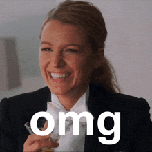 a woman in a tuxedo is smiling and holding a martini glass with the word omg above her