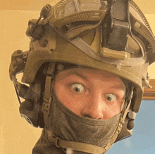 a man wearing a helmet and a mask makes a surprised face