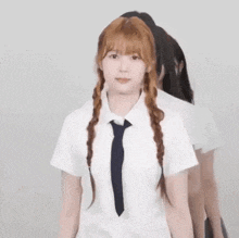 a girl in a white shirt and tie is dancing .