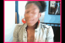 a woman is making a funny face in front of a picture