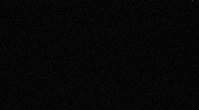 a close up of a black surface with a grainy texture