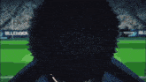 a close up of a person 's face with a blue sign behind them that says bluelock