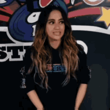 a woman wearing a black sweatshirt with the word low on it