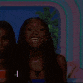 a woman is laughing while standing next to another woman on a stage .