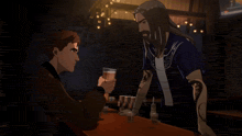 a man holding a glass of beer talks to another man in a dark room