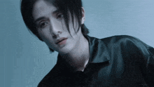 a close up of a man 's face with long hair