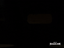 a silhouette of a person flying in a dark room with the words keluarga man written on the bottom