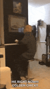 a bald man is sitting on a bar stool in a living room with the words `` me right now !! golden chick ! ''
