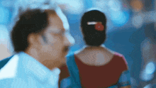 a man and a woman are standing next to each other in a blurry photo