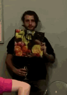 a man holding a bag of fruit and a glass