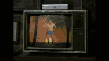 a man without a shirt is dancing on a tv screen