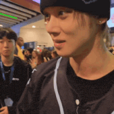a man wearing a beanie and a jacket with the word skyo on it