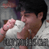 a man drinking from a cup that says orat stole his chai on it