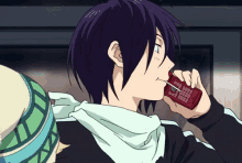 a boy with purple hair is talking on a red cell phone