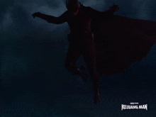 a man in a superhero costume is flying in the dark with the words keluarga man written below him