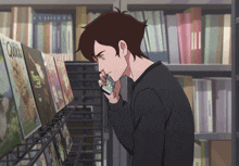 a man in a black sweater is looking at a book called quickie