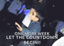 a man in a suit and sunglasses is dancing in a club .