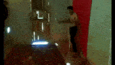 a man without a shirt is standing in front of a glass door