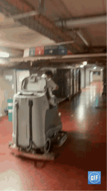 a gif of a person driving a cleaning machine