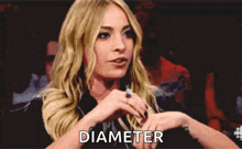 a woman with a ring on her finger has the word diameter written on her hand