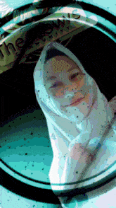 a woman in a white hijab is looking through a magnifying glass with the words the lows community on it