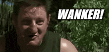 a man is making a funny face with the word wanker written above him