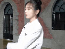 a blurry picture of a woman standing in front of a brick building