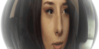 a close up of a woman 's face with a black nose