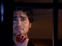 a man with blood on his face is crying