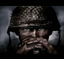a close up of a soldier wearing a helmet