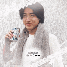 a man with a towel around his neck is holding a can of sun