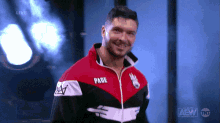 a man wearing a red white and black jacket with the word pade on the front