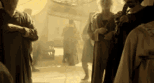 a group of people are standing in a dark room