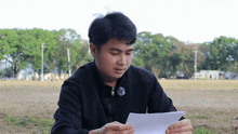 a young man in a black jacket with a button that says ' rb ' on it