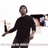 a man in a black shirt is dancing with the words pratortusweg 12a 20255 hamburg germany above him