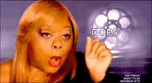 a woman is making a funny face with the words oops written on her finger