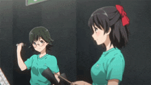 a girl in a green shirt with the letter h on the front