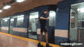 a gif of a man getting on a train with the url make a gif.com