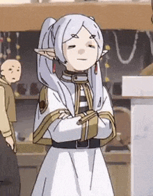 a cartoon character with white hair and ears is standing with her arms crossed .