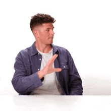 a man in a purple jacket says let me try in yellow letters