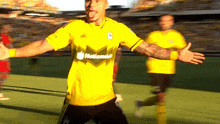 a soccer player wearing a yellow jersey that says nationals on it