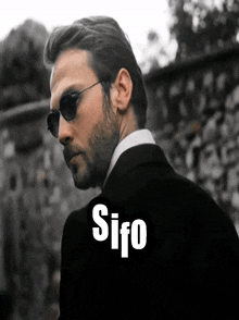 a man wearing sunglasses and a suit has the word sifo written on his back