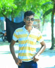 a young man wearing sunglasses and a striped shirt