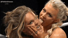 a woman is sticking her tongue out at another woman