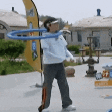 a person is holding a blue hula hoop in their hand .