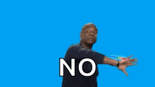 a man standing in front of a rainbow with the word no on his shirt .