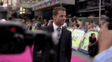 a man in a suit and tie is being interviewed